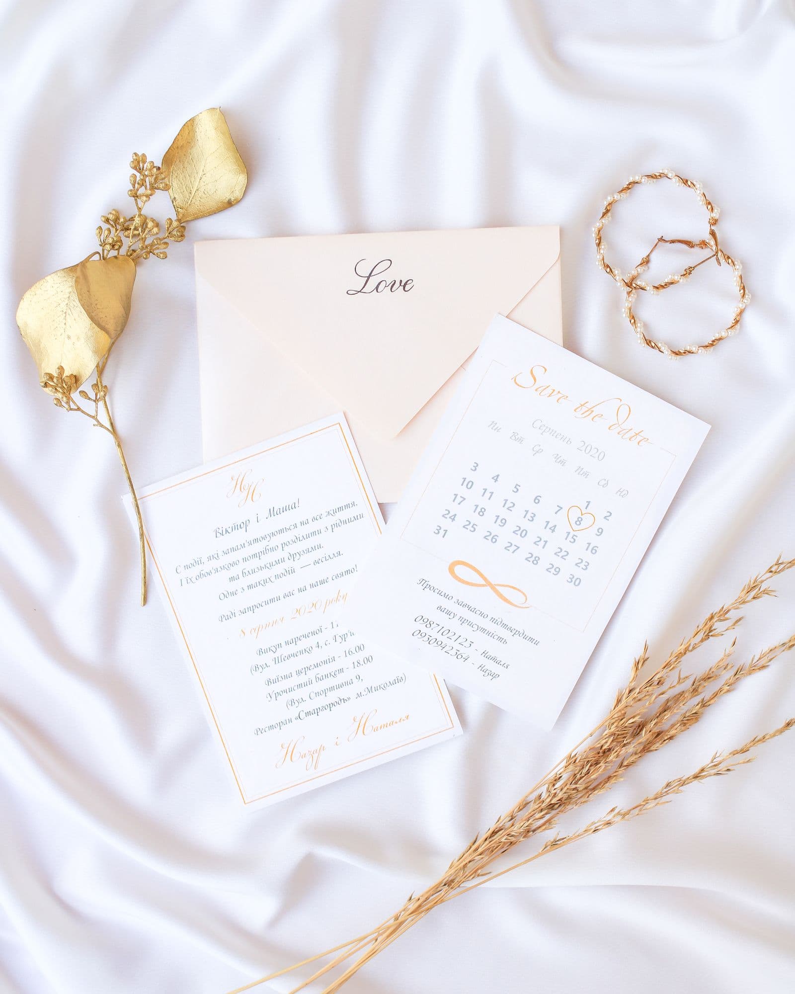 Wedding invitation arranged on white fabric